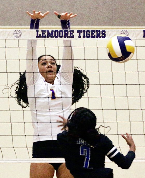 Lemoore's Nataliya Johnson saves a point from Hanford West's Amiera Hollis in the first game.